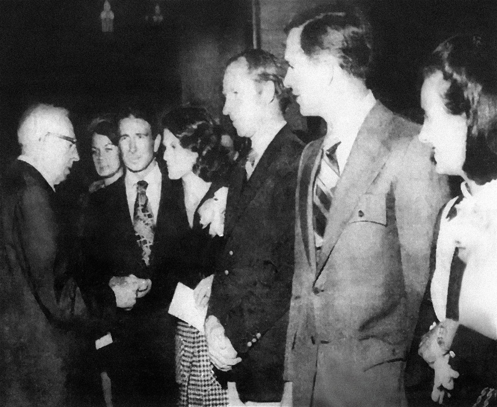 A black and white photograph from The Deseret News newspaper of Latter-day Saint prophet Joseph Field Smith shaking hands and greeting three astronaughts from Apollo 15 and their wives on September 14, 1971.