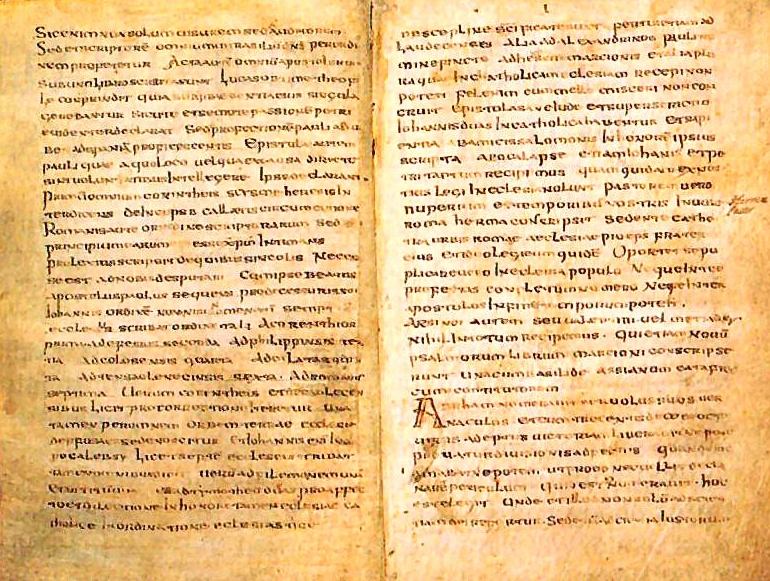An ancient manuscript featuring two pages of Latin text written in a dense, uniform script on aged parchment. The text is arranged in long lines without modern punctuation, and some letters are slightly faded due to the manuscript's age. The right-hand page includes an enlarged, decorated initial letter "A," which stands out from the rest of the script.