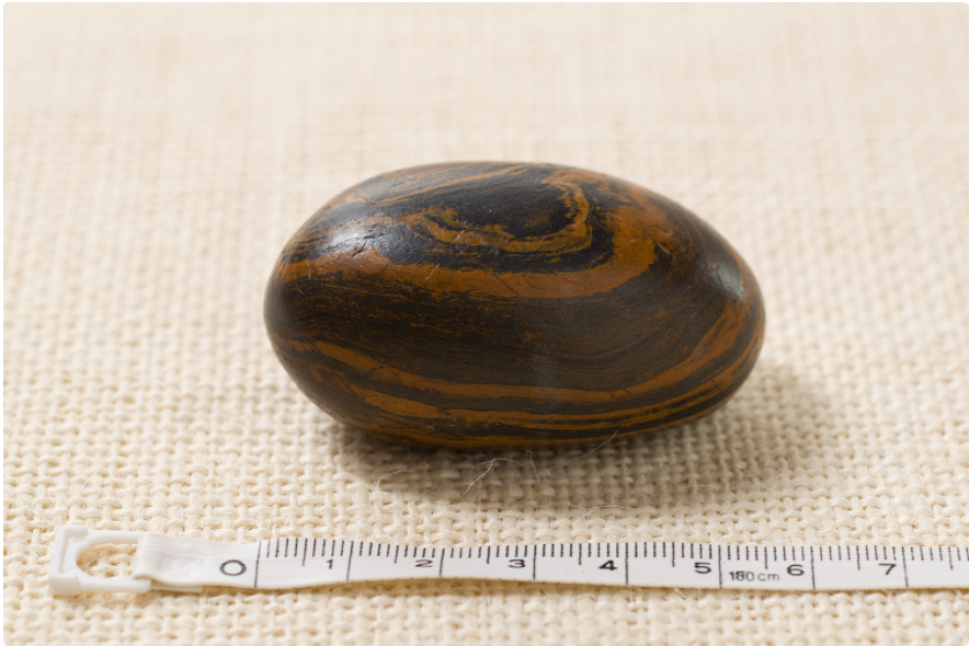 Photograph of a brown, 5.5 cm seer stone associated with Joseph Smith
