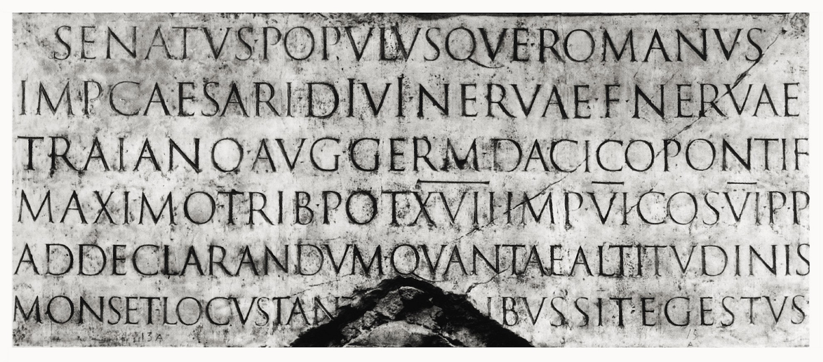 Ancient Roman stone inscription found in Trajan's Column, in Latin with chiseled capital letters, exemplifying classic Roman square capitals used in imperial monuments.
