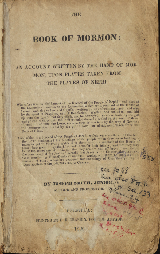 The title page of B. H. Roberts's personal copy of the 1830 first edition of the Book of Mormon. The page reads "The Book of Mormon: An Account Written by the Hand of Mormon, Upon Plates Taken from the Plates of Nephi" and includes publication information from Palmyra, printed by E. B. Grandin. Numerous handwritten annotations in blue, black, and red ink appear in the margins and lower half of the page, referencing scriptures and page numbers, reflecting Roberts's study and analysis of the text.