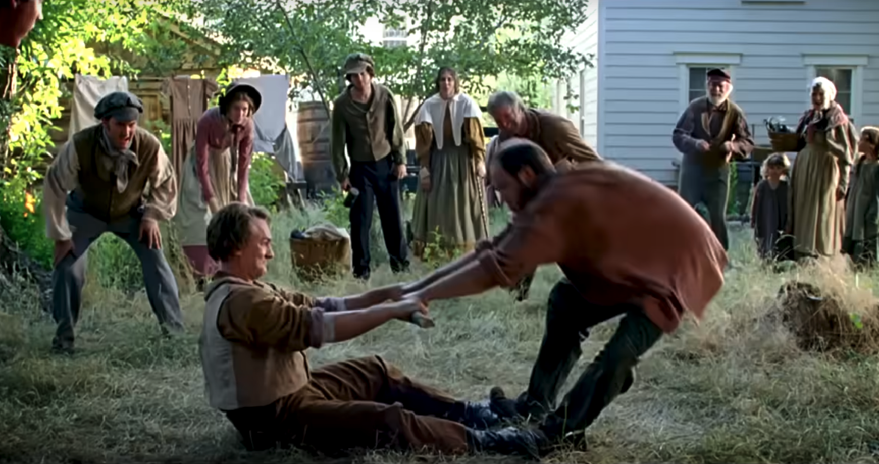 Screenshot from film, Joseph Smith playing a stick-pulling game with someone